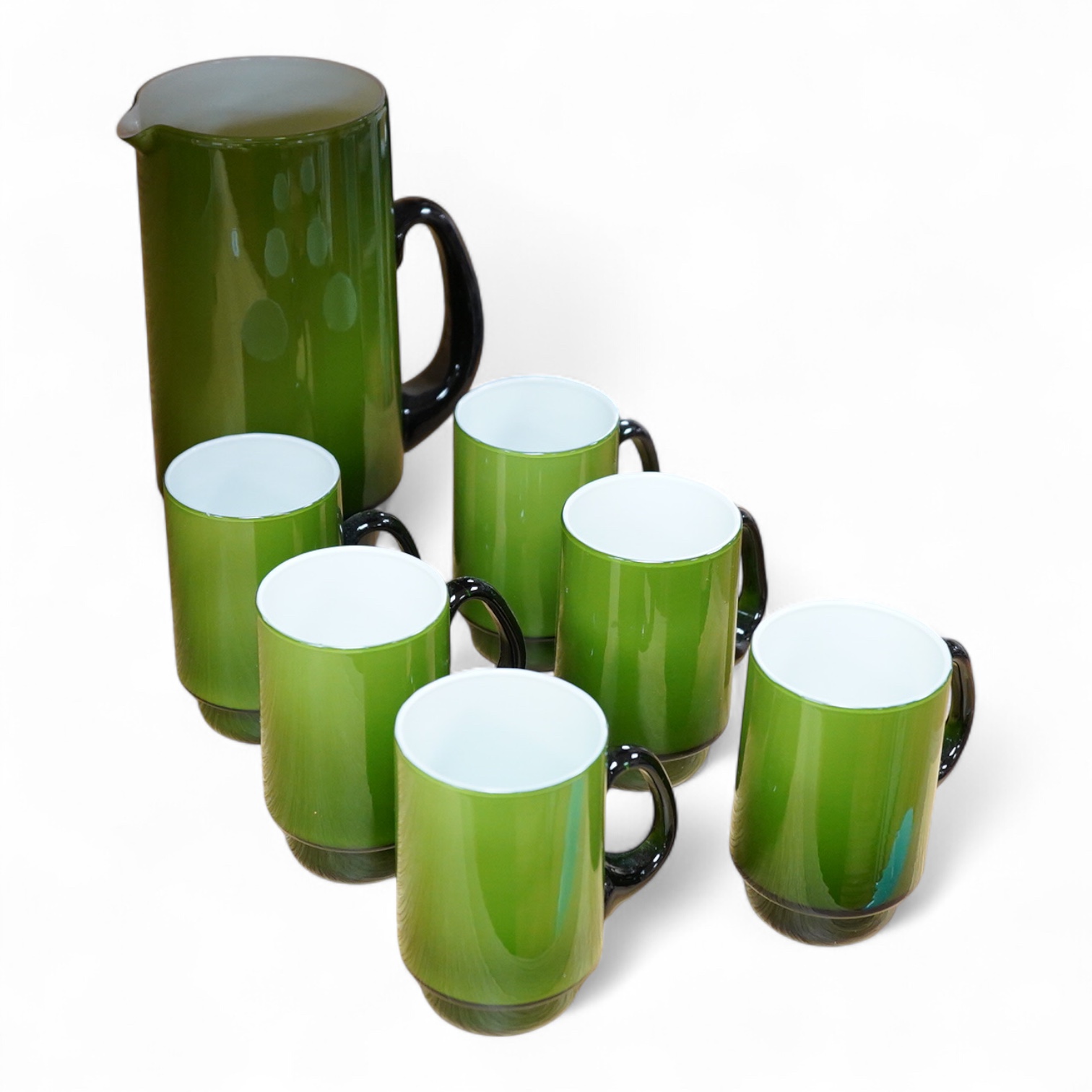 Michael Bang for Holmegaard glass, a green cased jug and six mugs with stepped bases, largest 20cm high